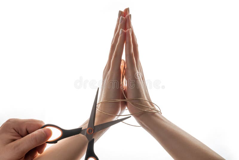 Cutting A Rope With Scissors Against White Background Stock Photo