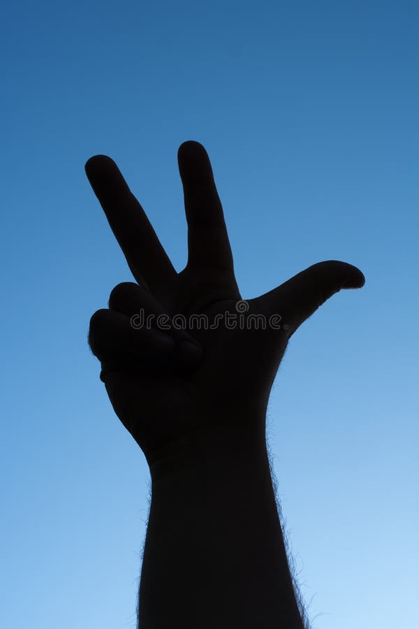 Man hand showing number three in outdoors. Man hand showing number three in outdoors