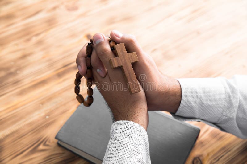 Man hand cross on Bible royalty free stock image Man hand cross on Bible royalty free stock image