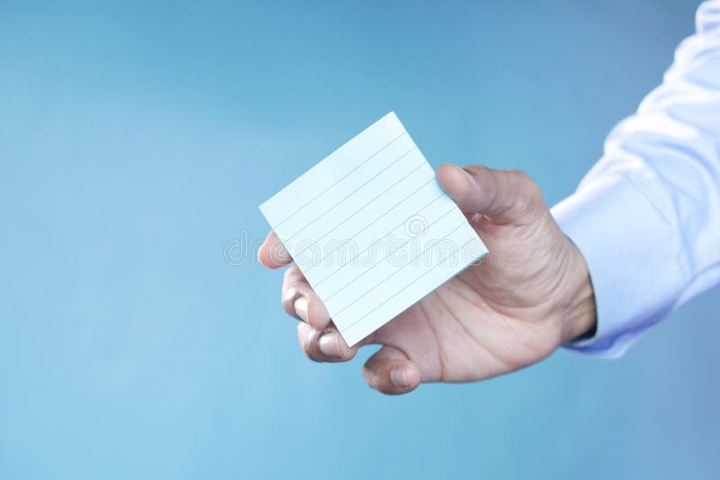 Man Hand Hold a Sticky Note Against Blue Background Stock Image Image