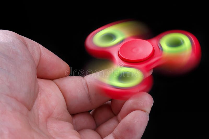 Man Hand Holding Fidget Spinner on Black Background Stock Photo Image