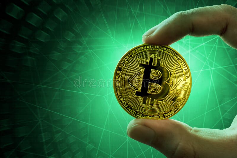 Man hand holding golden bitcoin stock photo