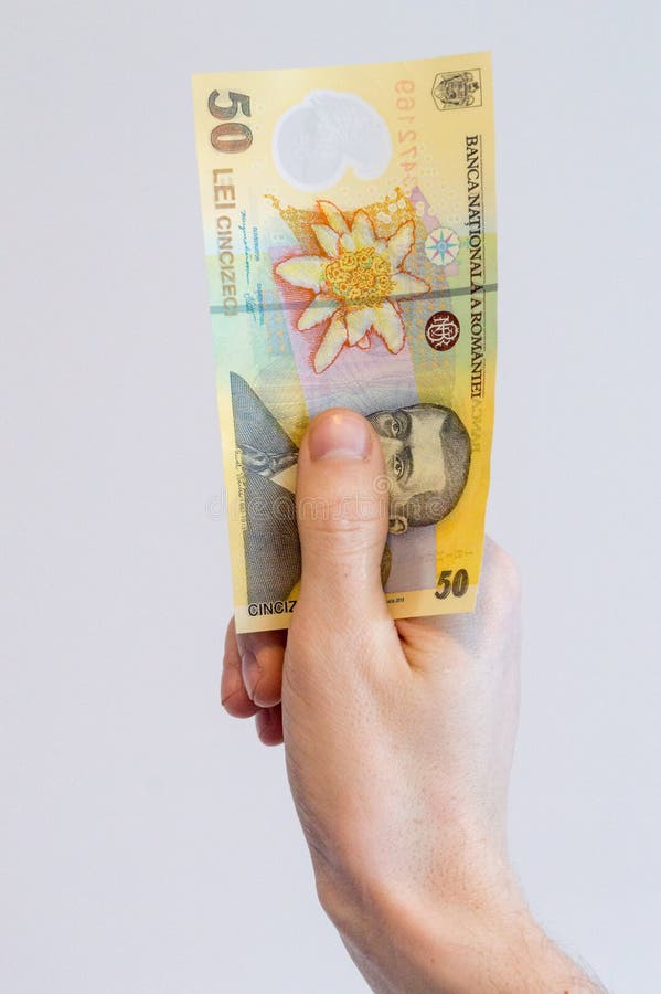 Man hand holding a 50 Romanian lei banknote