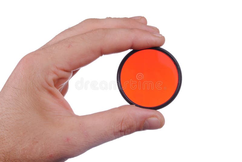 Man hand holds a red photographic filter