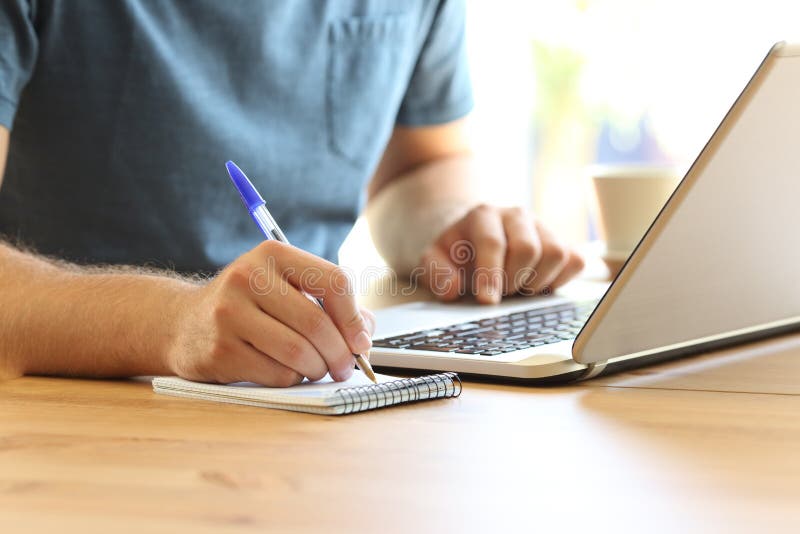 Man hand on line taking notes in a notebook royalty free stock photography Man hand on line taking notes in a notebook royalty free stock photography