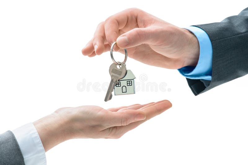 Man is handing a house key to other hands stock photos Man is handing a house key to other hands stock photos