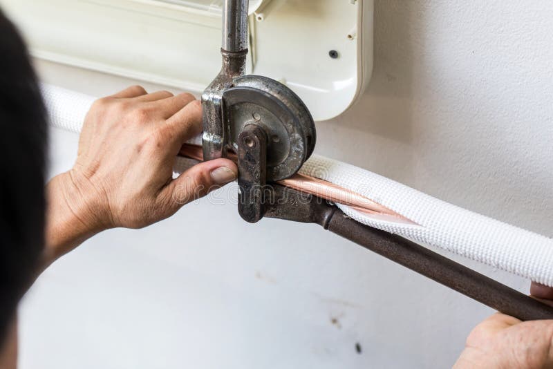 Man Hands Bends Copper Pipes by Pipe Bender. Air Conditioner Technician