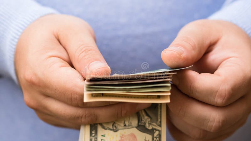 Man hands counting money, counting US dollars currency, close up stock image Man hands counting money, counting US dollars currency, close up stock image