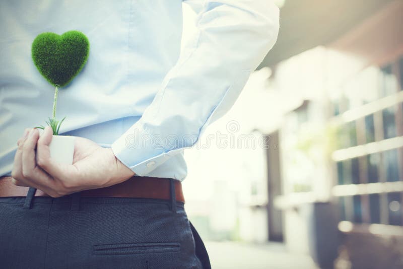 Man hands holding surprise gift from behind - love and relations