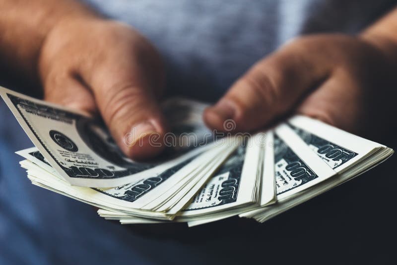 Man hands holding usa dollar banknotes spread out by fan, making cash money success concept. Selective focus on money stock image Man hands holding usa dollar banknotes spread out by fan, making cash money success concept. Selective focus on money stock image