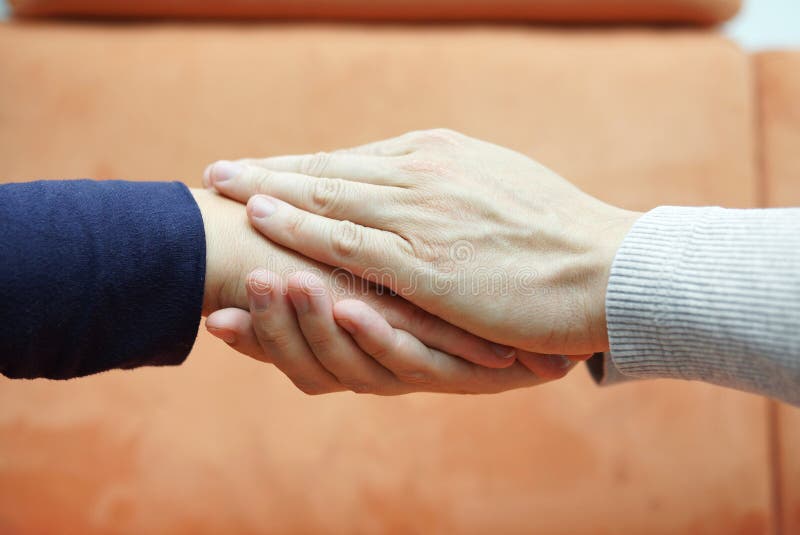Man hands holding woman hand from both sides. Compassion stock photo