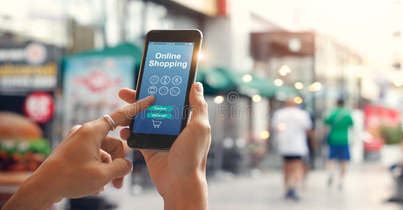 Male hands using smartphone for online shopping on street in city royalty free stock photography Male hands using smartphone for online shopping on street in city royalty free stock photography