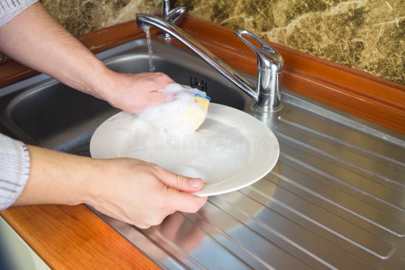 Man Hands, Washing a Sponge with Foam the Dishes at the Kitchen. Stock Photo Image of dirty