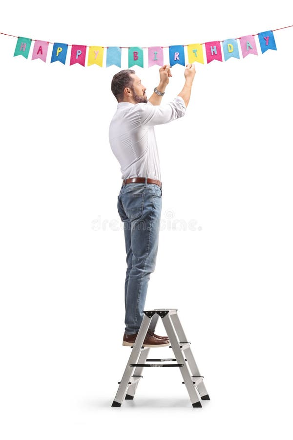 Man hanging birthday decorations isolated on white background fotografie stock libere da diritti