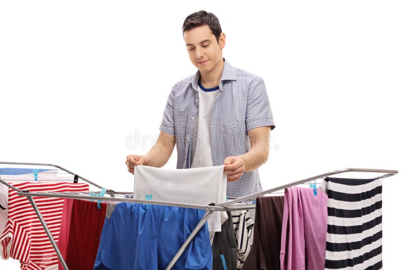 Man hanging clothes on a rack dryer