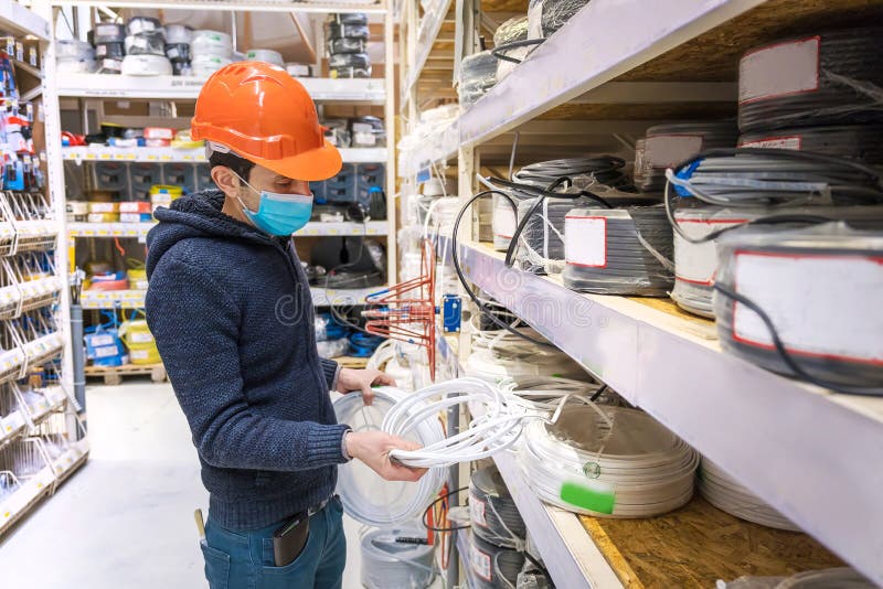 A Man in a Hardware Store. Sells Electrical Cables. Selective Focus