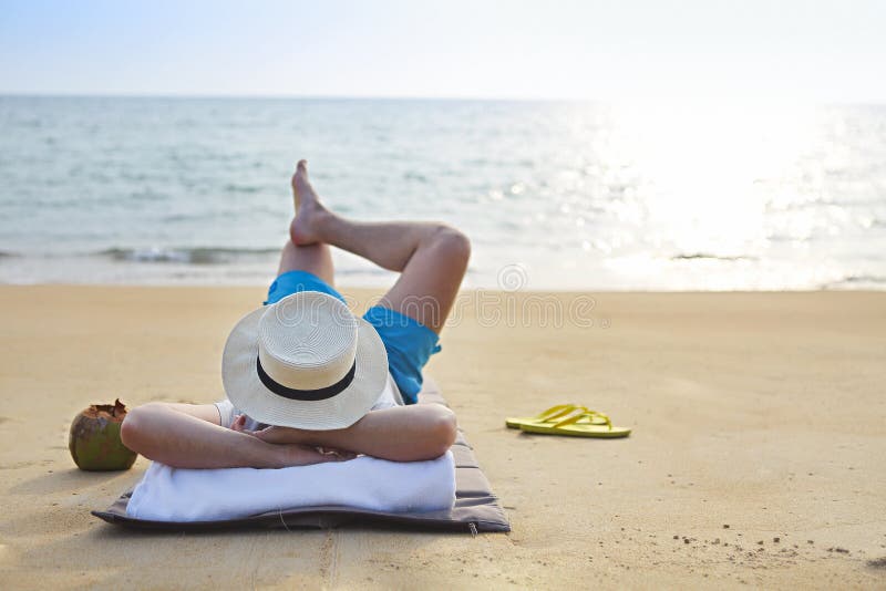 man-hat-coconut-cocktail-beach-young-140963905.jpg