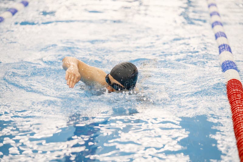 Man an in Hat Swimming in Indoors Swimming Pool Breaststroke Stock ...