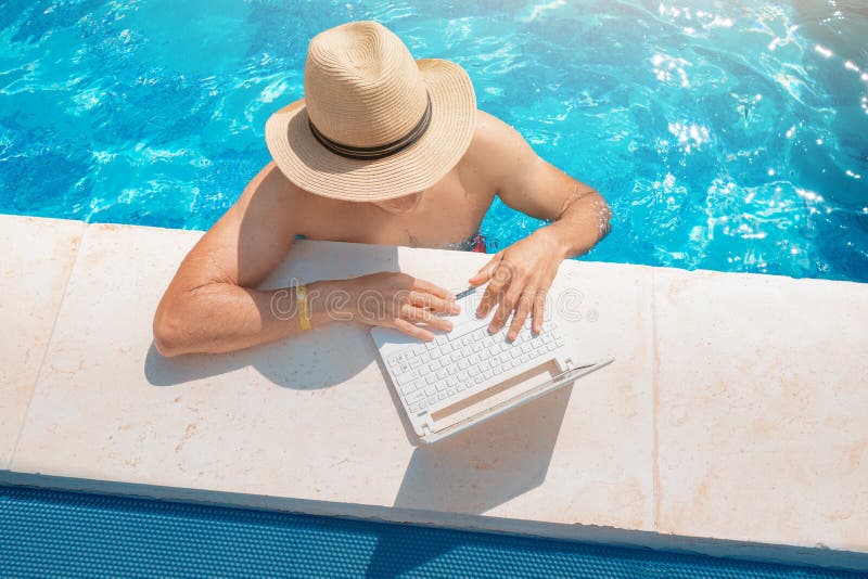 Man surfing internet through his laptop or notebook pc. Studying at online university and remote work royalty free stock image