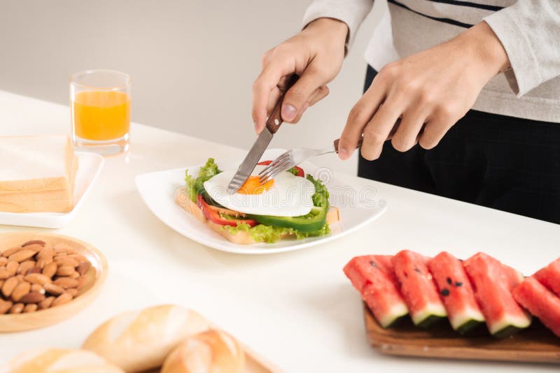 A Man Having Breakfast with Knife and Fork Stock Photo Image of plate
