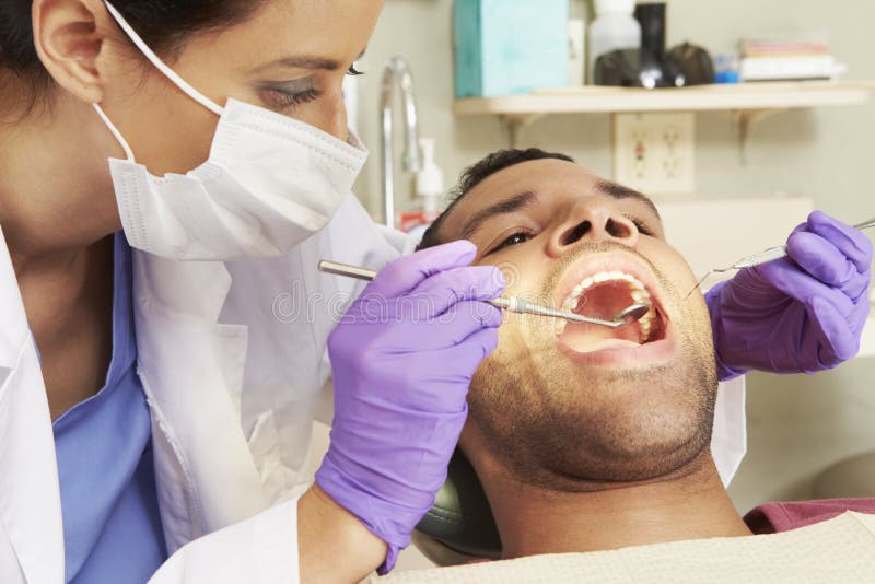 Man Having Check Up At Dentists Surgery royalty free stock photo Man Having Check Up At Dentists Surgery royalty free stock photo