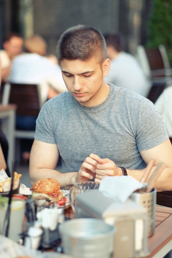 Man Having Cheeseburger in Restaurant Stock Photo Image of lifestyle