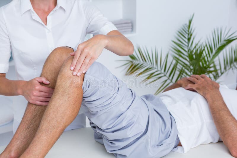 Man having knee massage stock image. Image of examination 54759665