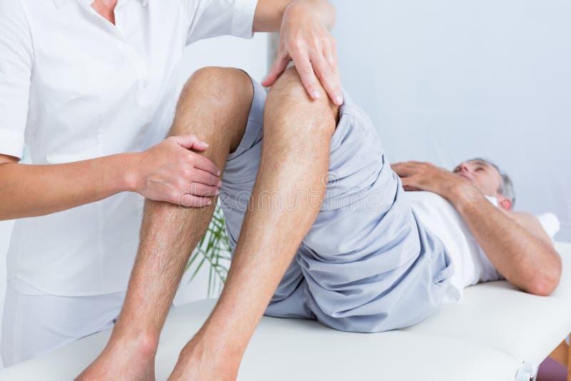Man having knee massage stock image. Image of examination 54759665