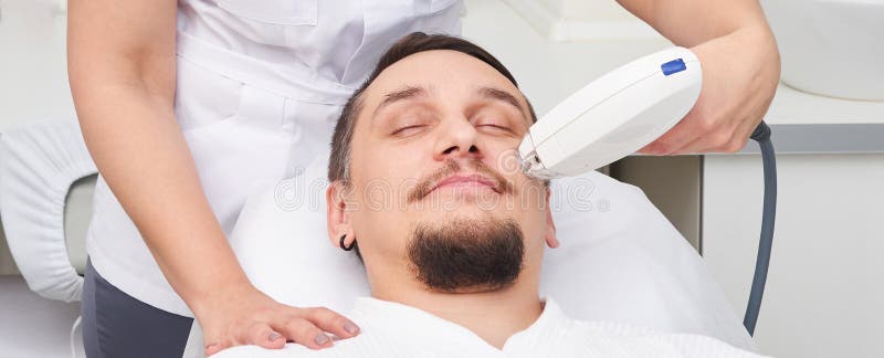 Man Having Laser Treatment At Beauty Clinic Stock Photo Image Of