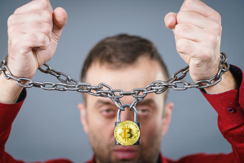 Man being tied up in block chain stock photography Man being tied up in block chain stock photography