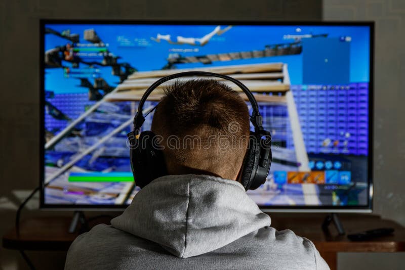 Man with headphones play video game