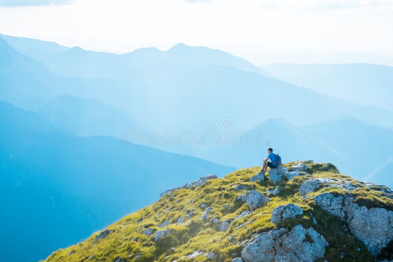 Man hiker on top of mountain