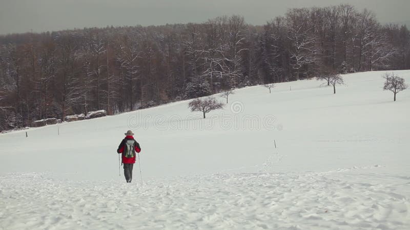 Man hiking outdoors at snow at sunny day