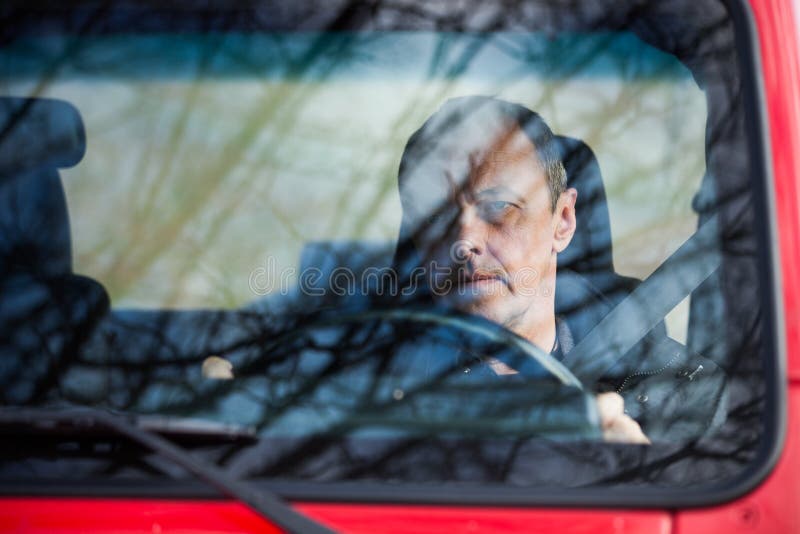 Man in his car behind wheel front view royalty free stock photo
