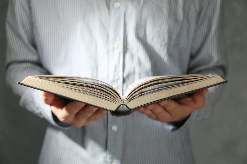 Man hold book in hands stock image Man hold book in hands stock image