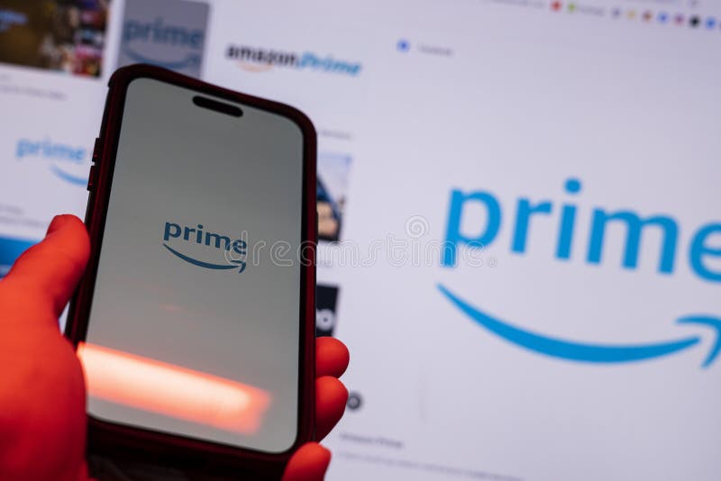 Man holding an Apple iPhone 14 Pro Max smartphone with Amazon Prime Video app on the screen Office environment. stock photos