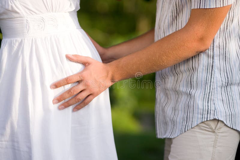 Man holding belly of pregnant