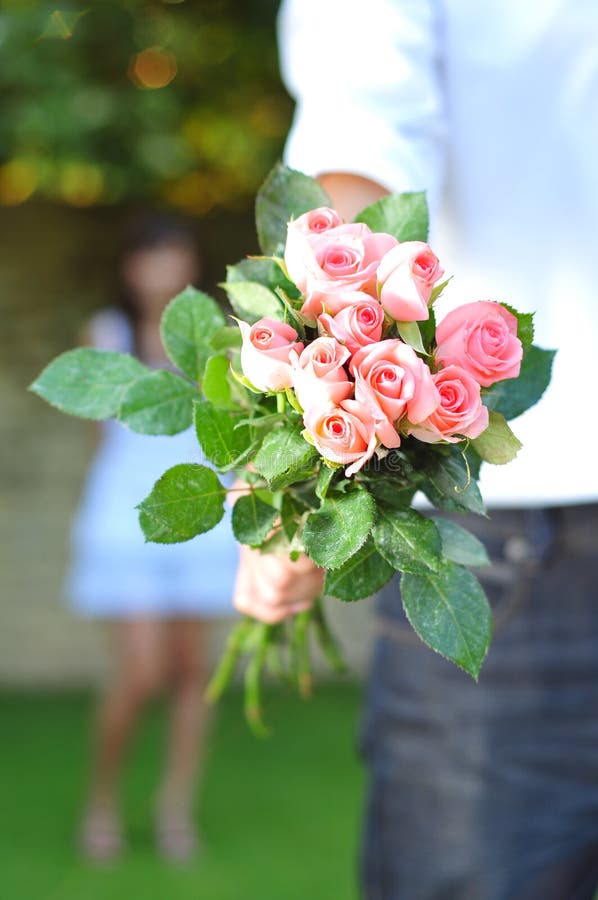 Man Holding A Bouquet Of Flowers