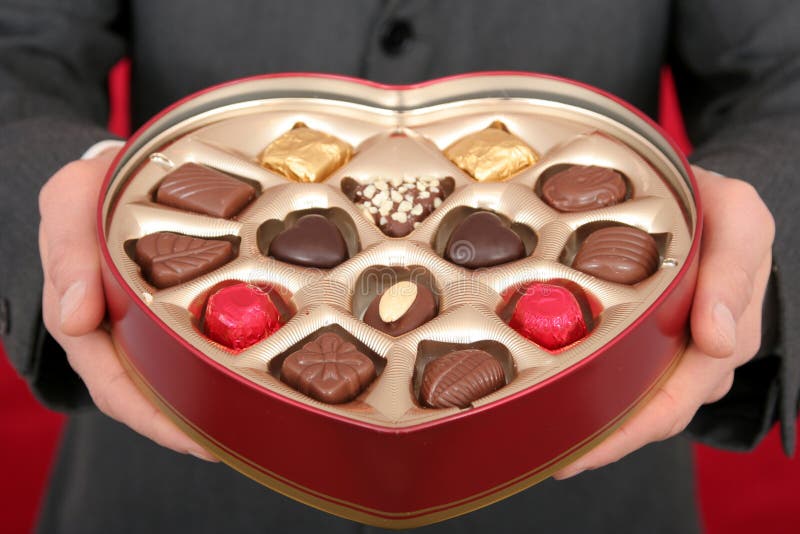 Man Holding Heart Shaped Box of Candy. Male hand holding businessman stock images, royalty-free photos and pictures