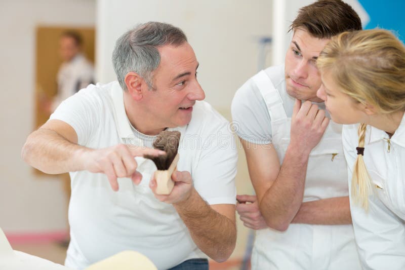 Man holding brush with students royalty free stock images