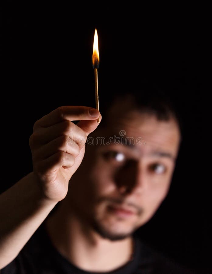 Man Holding Burning Match While Lighting Candles In Dark Kitchen During Power  Outage Stock Photo, Picture and Royalty Free Image. Image 194083174.