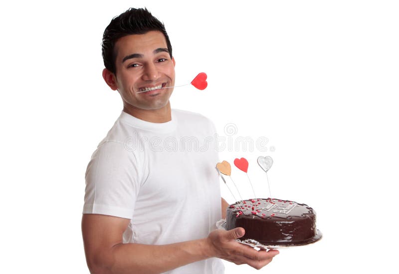 Man holding chocolate cake with love hearts. 