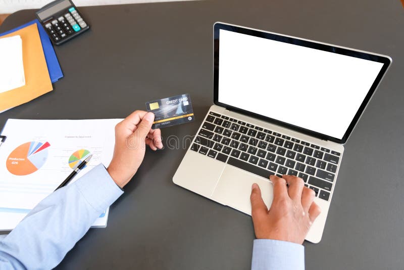 Man holding credit card using computer for online shopping. businessman make payment on website royalty free stock image