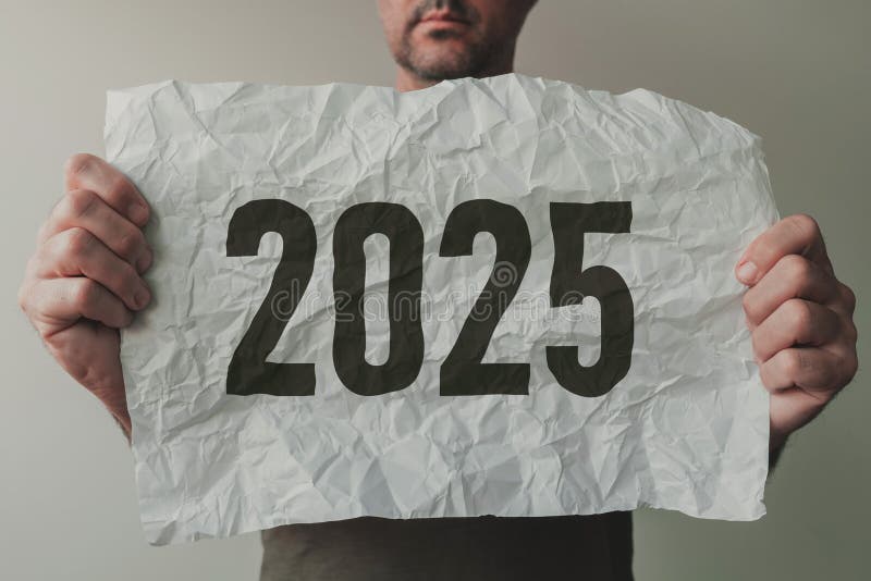 Man holding crumpled white paper with number 2025 stock photos