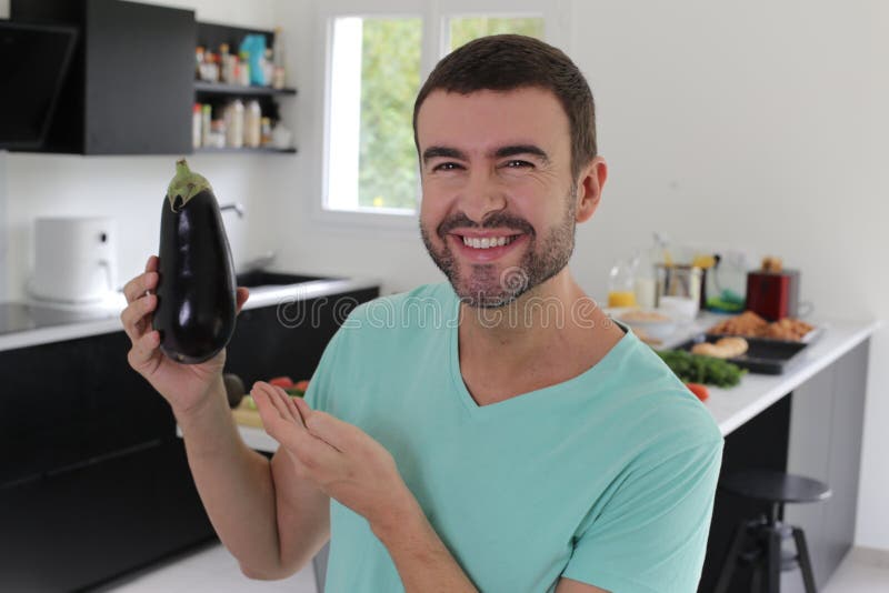 Man Holding a Delicious Eggplant Stock Photo Image of chef, kitchen