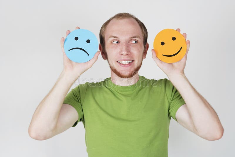 Man holding emotion smile symbols