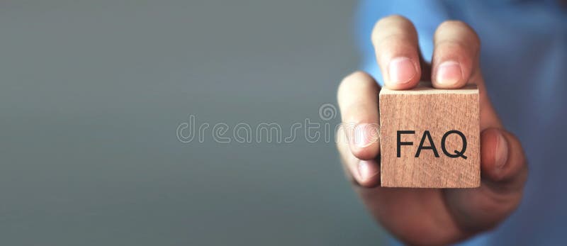Man holding FAQ message on wooden cube. Frequently Asked Questions