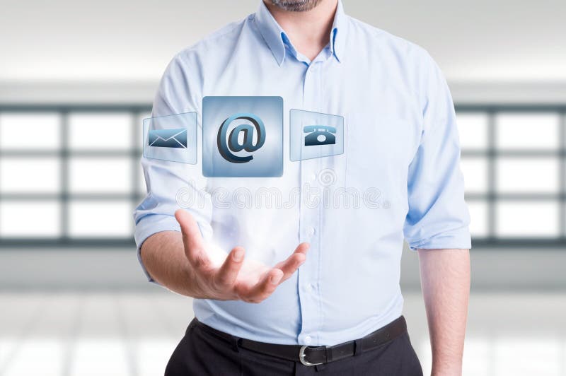 Business man holding futuristic contact us floating icons. Support, assistance or feedback concept