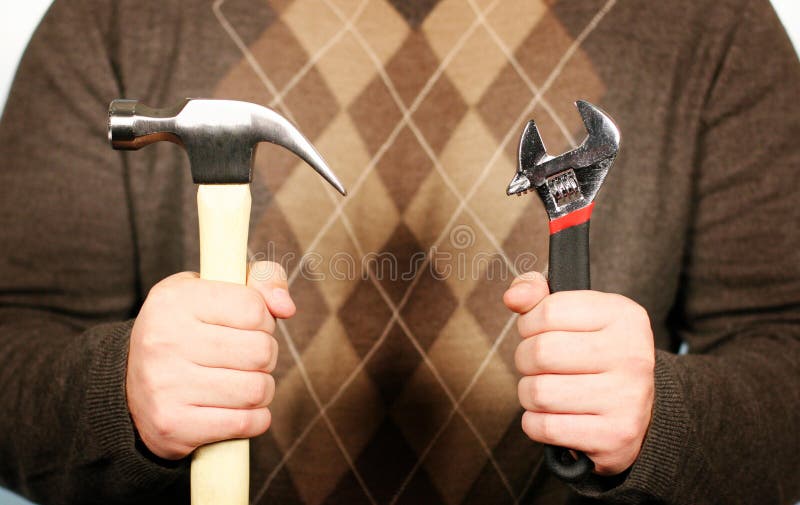 Man holding hammer and wrench