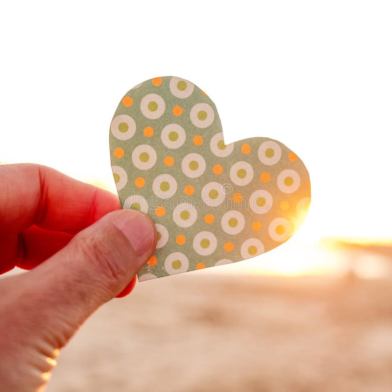 Man holding a heart cut at dawn or sunset stock images Man holding a heart cut at dawn or sunset stock images